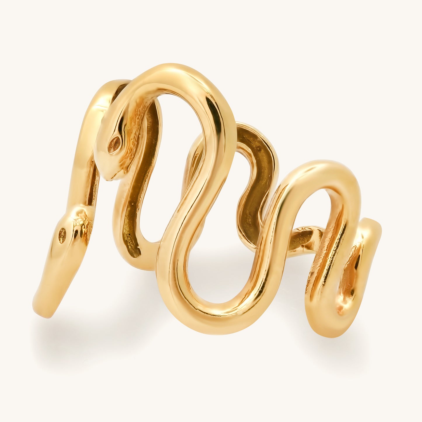This exquisite gold snake ring, a testament to elegance and style, draws inspiration from the unique personality of my dear friend Cynthia. Crafted with meticulous detail, the coiled serpent design gracefully wraps around the finger, reflecting both sophistication and the spirit of friendship. This photo shows a side view of the snake ring.